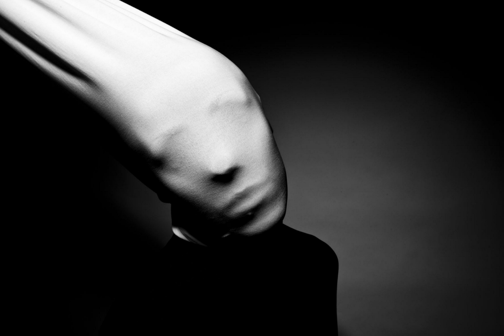 Black and white face being pulled back with fabric